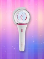 Un lightstick Stayc Wink Bong blanc et rose, présentant un manche blanc et un bulbe translucide avec le logo du groupe au centre, sur un fond artificiel coloré avec un gradient allant du rose au violet.