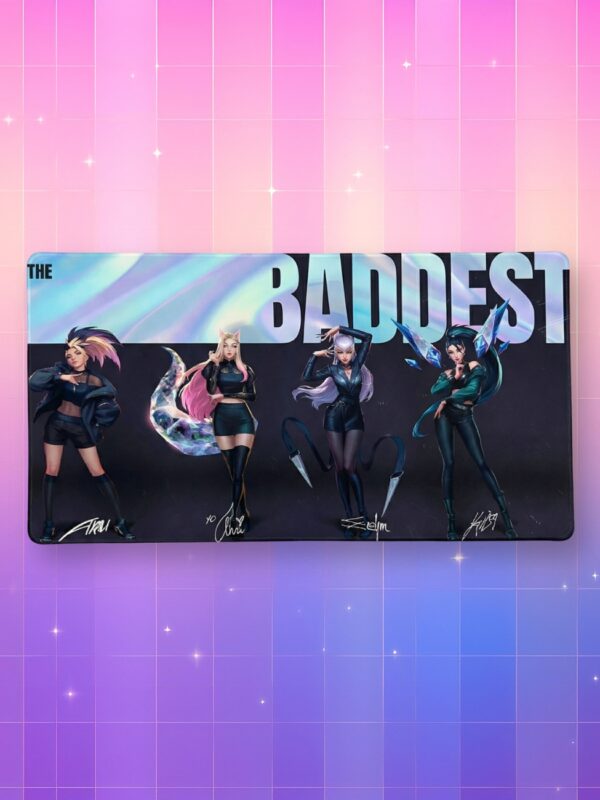 Un tapis de souris kpop KDA The Baddest illustrant les quatre chanteuses du groupe en tenues sombres et stylées sur un fond noir, surmonté d'une bannière holographique avec le titre, présenté sur un arrière-plan quadrillé aux couleurs dégradées rose et violet avec des étoiles.