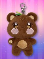 Une peluche porte-clés JJONGbear ANITEEZ marron, avec de grandes oreilles, des joues roses et un ventre beige, présentée sur un fond rose et violet quadrillé.